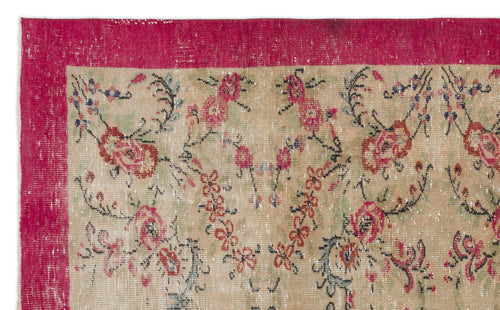 Load image 1 in gallery view. Distressed beige rug with a wide magenta border and a floral vine pattern in red, green, and black.