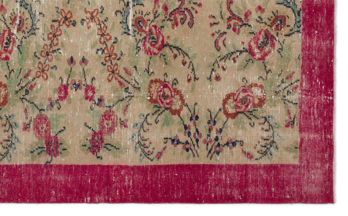 Load image 1 in gallery view. Distressed beige rug with a floral pattern in red, green, and black, featuring a wide, solid red border.