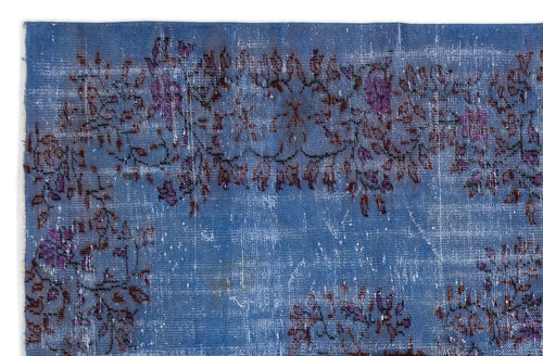 Load image 1 in gallery view. Distressed blue rug with a faded floral vine pattern in shades of purple and dark brown.