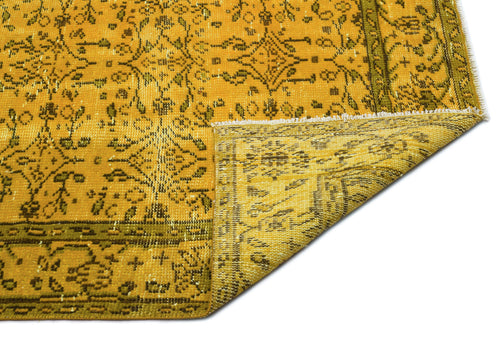 Load image 1 in gallery view. Mustard yellow and olive green traditional rug with a distressed floral medallion pattern and a folded corner.