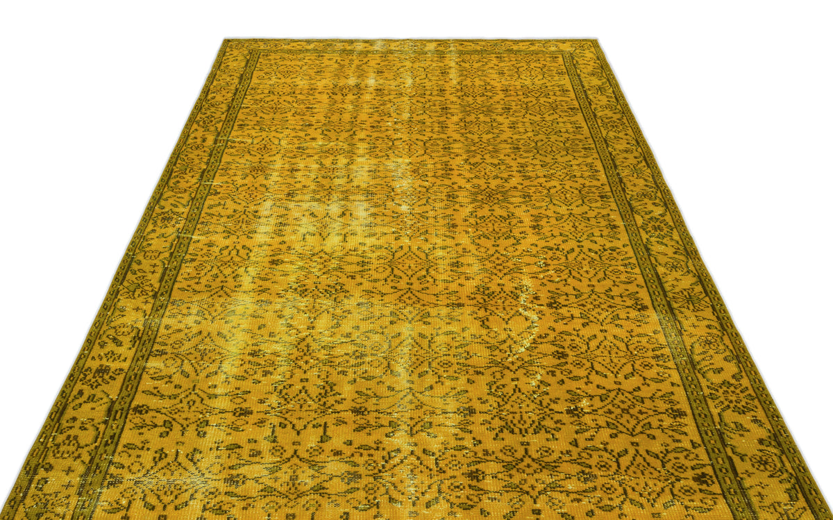 Mustard yellow vintage-style rug with a distressed floral pattern and a dark border on a white background.