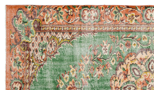 Load image 1 in gallery view. Distressed green and orange rug with a traditional floral medallion pattern and ornate border.