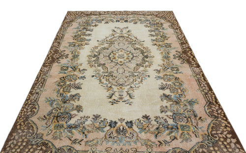 Load image 1 in gallery view. Beige and peach vintage-style rug with a central floral medallion and dark brown ornate border.