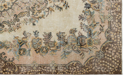 Load image 1 in gallery view. Distressed beige and peach rug with a floral medallion pattern and dark brown border.