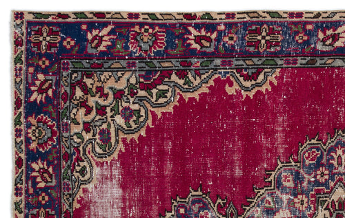 Load image 1 in gallery view. Distressed magenta rug with a navy blue floral border and intricate beige, green, and red traditional patterns.