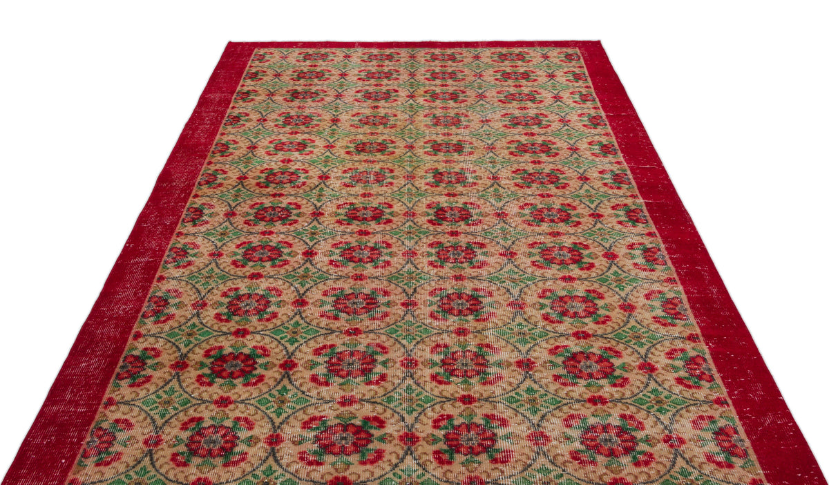 Red, green, and beige vintage-style rug with a repeating circular floral medallion pattern and a solid red border.