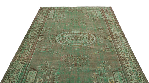 Load image 1 in gallery view. Distressed sage green and brown vintage-style rug with a central medallion and ornate geometric border.