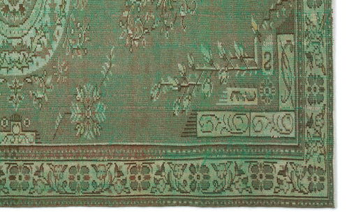 Load image 1 in gallery view. Distressed sage green and brown rug with a traditional floral medallion pattern and a geometric border.
