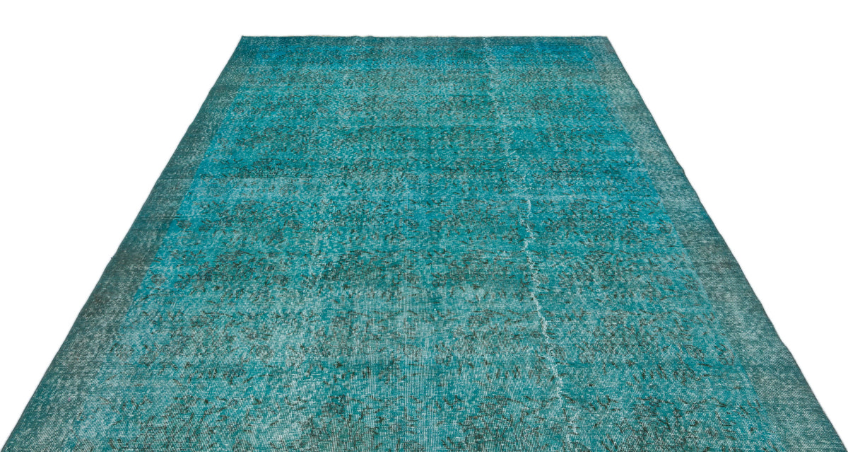Teal and black distressed vintage-style rug with a faded, worn-in texture on a white background.