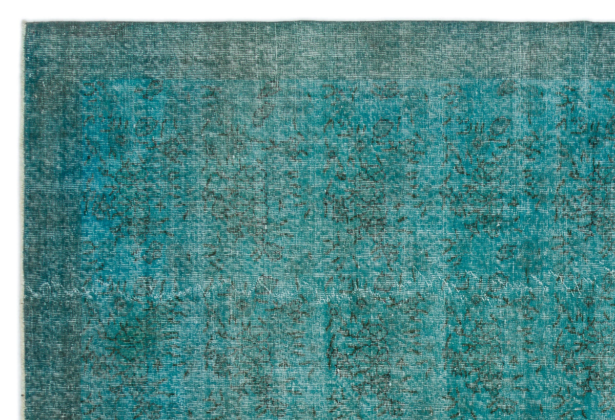 Teal and black distressed vintage-style rug with a faded, overdyed texture and subtle worn pattern.