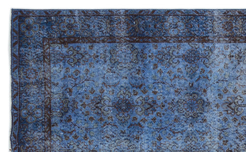 Load image 1 in gallery view. Blue and dark brown distressed traditional rug with a faded floral medallion pattern and a bordered edge.