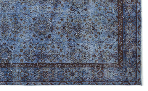 Load image 1 in gallery view. Blue and brown distressed traditional rug with a floral medallion pattern and a detailed border.