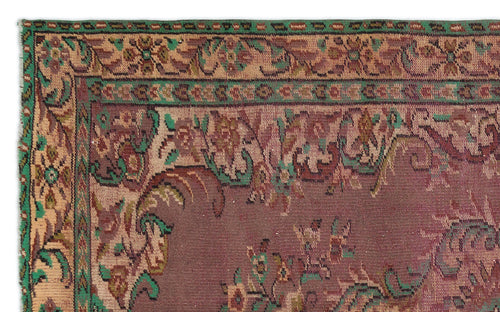 Load image 1 in gallery view. Traditional rug with a deep mauve field, featuring a floral border in green, tan, and brown tones.