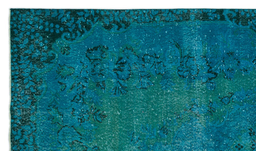 Load image 1 in gallery view. Teal and dark blue distressed rug with a faded floral medallion pattern.