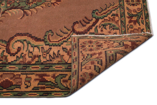 Load image 1 in gallery view. Brown, green, and tan traditional rug with a folded corner revealing the woven underside and intricate border pattern.
