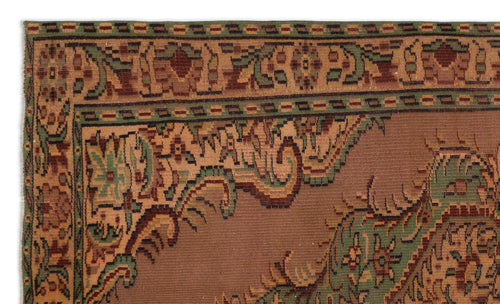 Load image 1 in gallery view. Brown, green, and tan traditional rug with an intricate floral border and central medallion pattern.