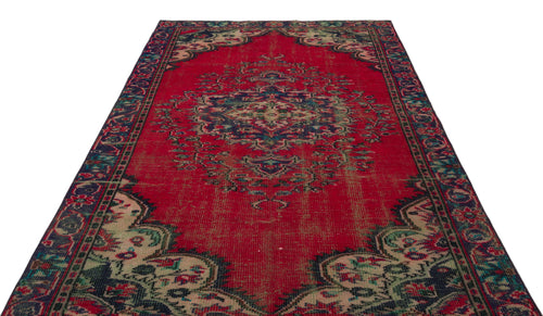 Load image 1 in gallery view. Distressed red traditional rug with a central navy and cream floral medallion and ornate border on a white background.