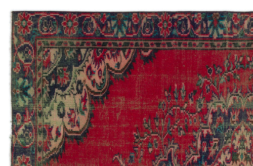 Load image 1 in gallery view. Red traditional rug with a dark green border, floral motifs, and a distressed, weathered texture.