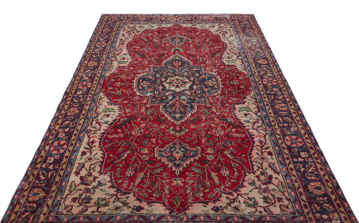 Red and navy blue traditional Persian-style rug with a central floral medallion and intricate border on a white background.