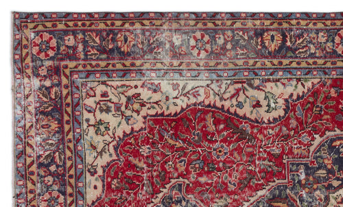 Load image 1 in gallery view. Distressed traditional rug with a red central field, cream floral motifs, and a multi-layered blue and tan border.