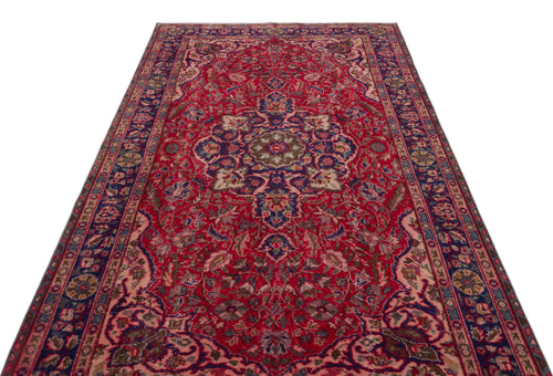 Load image 1 in gallery view. Red and navy blue traditional Persian-style rug with a central floral medallion and intricate border patterns.
