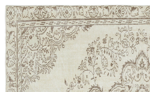 Load image 1 in gallery view. Cream rug with a distressed brown traditional floral medallion pattern and a detailed border.