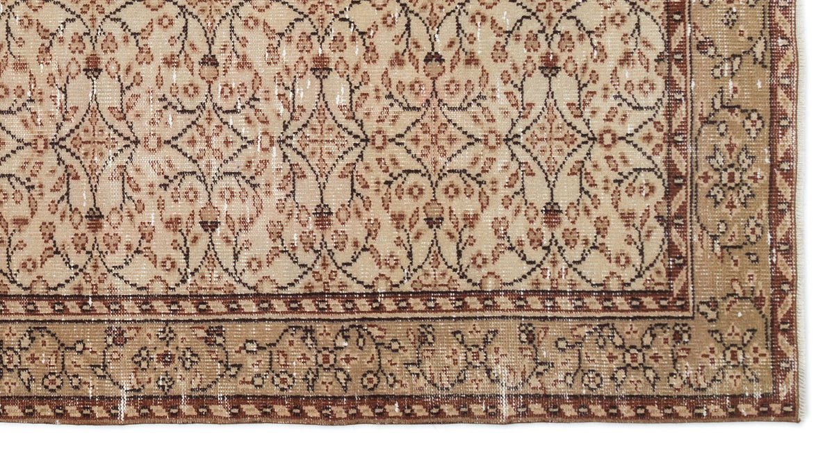 Beige and brown vintage-style rug with a distressed floral trellis pattern and a decorative border.