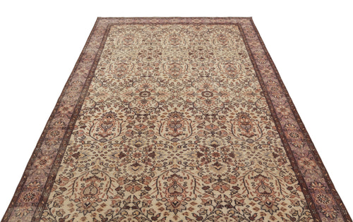 Load image 1 in gallery view. Beige and brown traditional rug with a distressed floral medallion pattern and a wide decorative border.