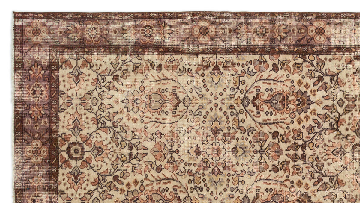 Beige, brown, and muted mauve traditional rug with an intricate floral medallion pattern and a wide decorative border.