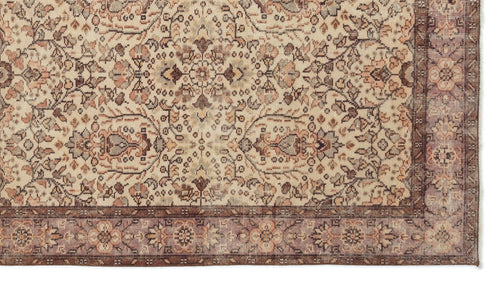 Load image 1 in gallery view. Beige, brown, and muted mauve traditional rug with an intricate floral medallion pattern and a wide decorative border.