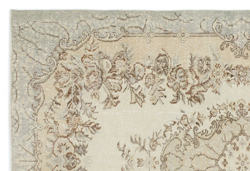 Load image 1 in gallery view. Distressed beige and light blue rug with a faded floral medallion pattern.