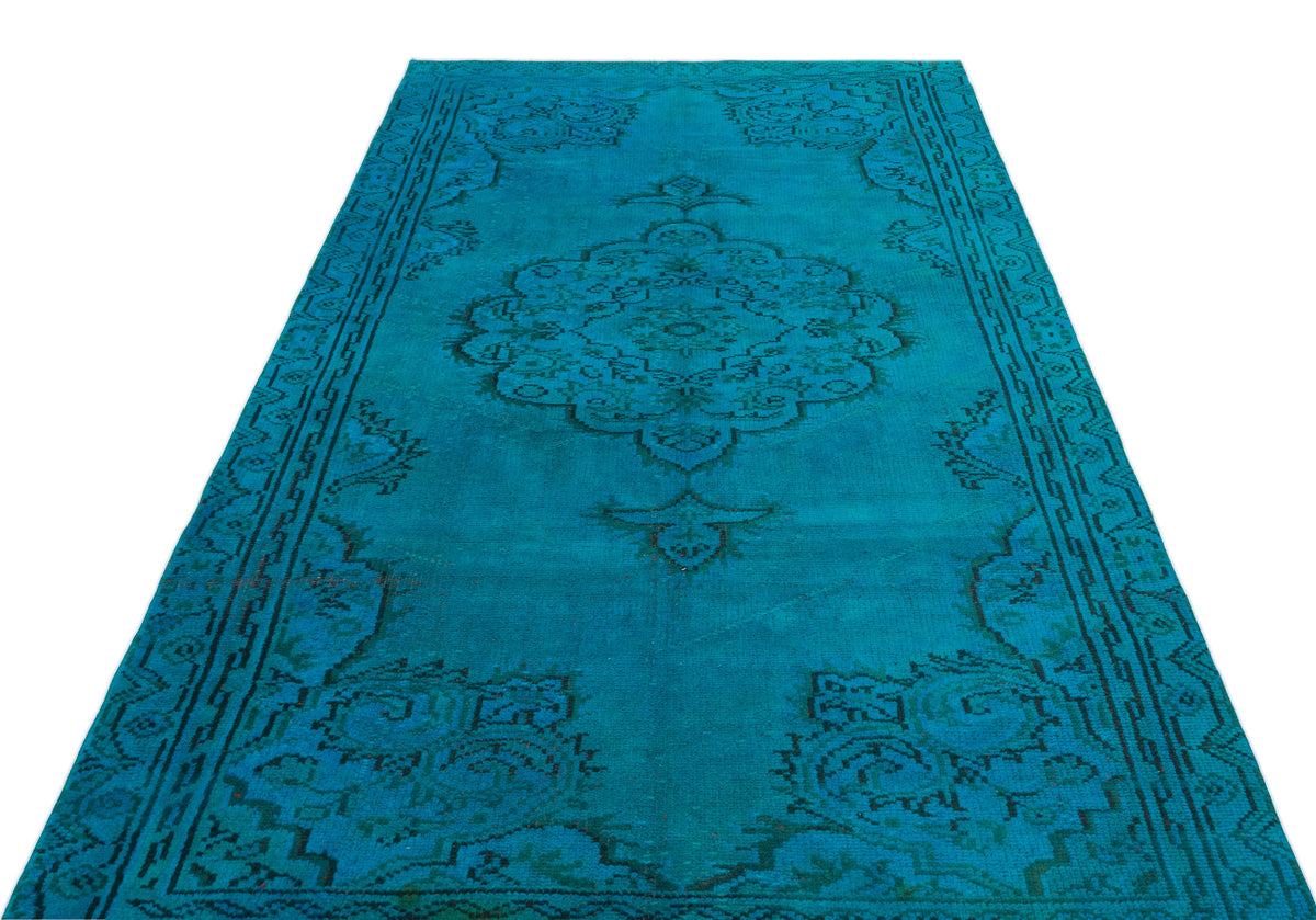 Teal rug with a dark green traditional floral medallion pattern and a decorative border on a white background.