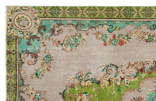 Load image 1 in gallery view. Distressed beige rug with green and teal floral borders and ornate botanical motifs on a neutral field.