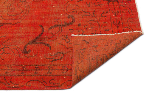Load image 1 in gallery view. Vibrant red rug with a dark brown floral pattern and a folded corner revealing the textured underside.