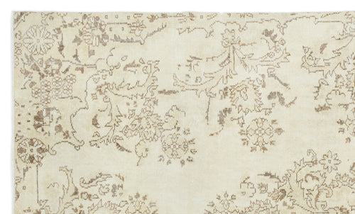 Load image 1 in gallery view. Cream rug with a distressed brown floral and vine pattern.