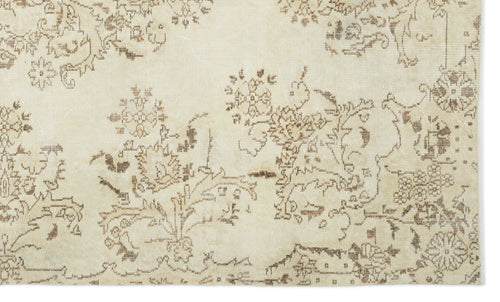 Load image 1 in gallery view. Cream rug with a distressed brown floral and vine pattern.