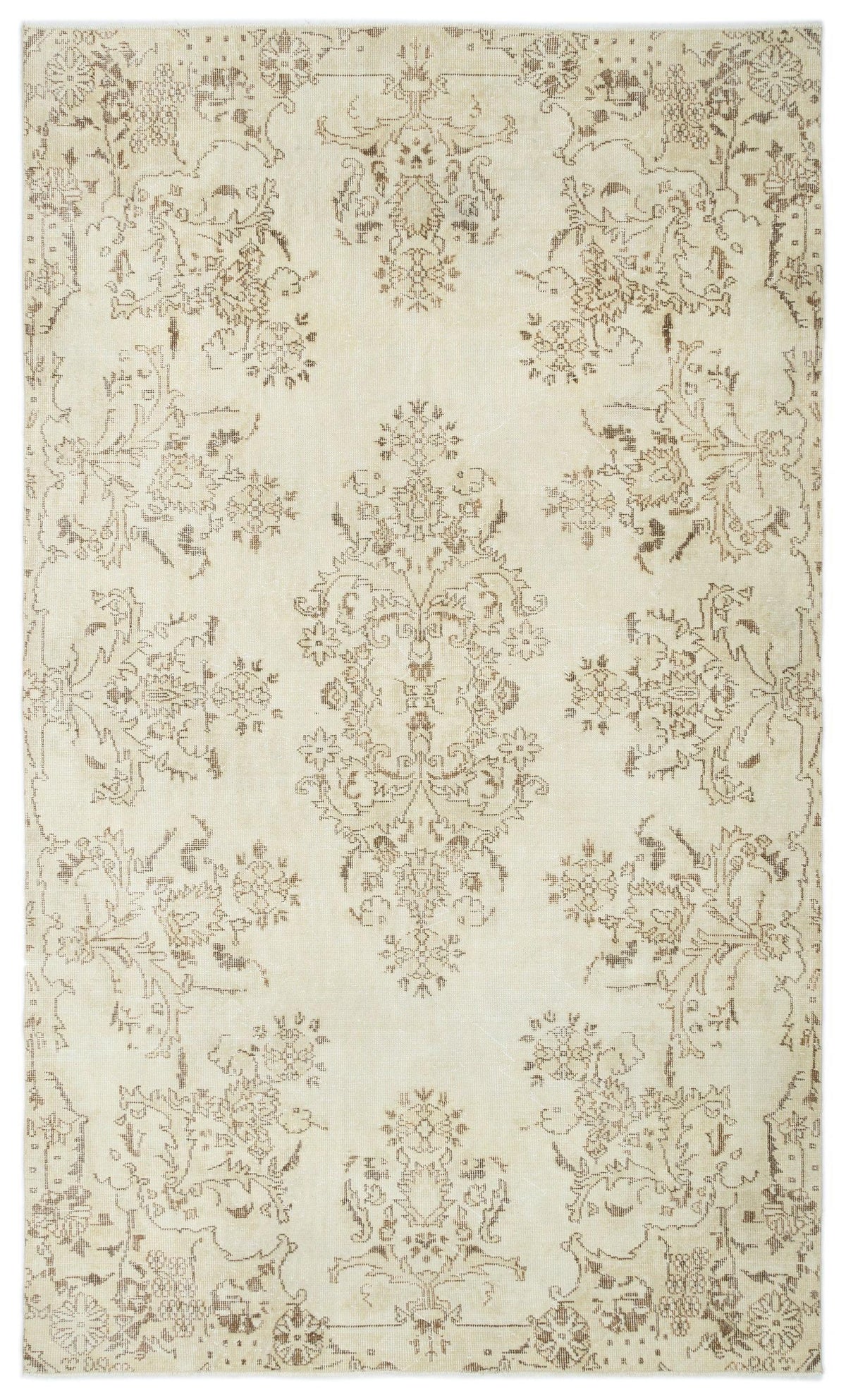 Cream rug with a distressed brown floral medallion pattern and symmetrical botanical motifs.