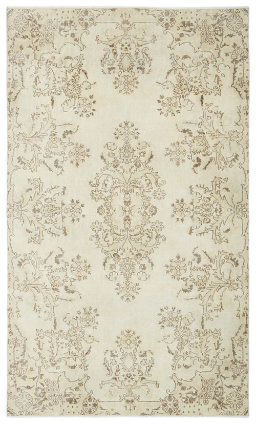 Load image 1 in gallery view. Cream rug with a distressed brown floral medallion pattern and symmetrical botanical motifs.