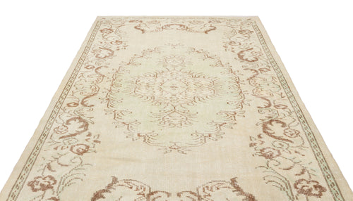 Load image 1 in gallery view. Beige and light green vintage-style rug with a central floral medallion and ornate border on a white background.