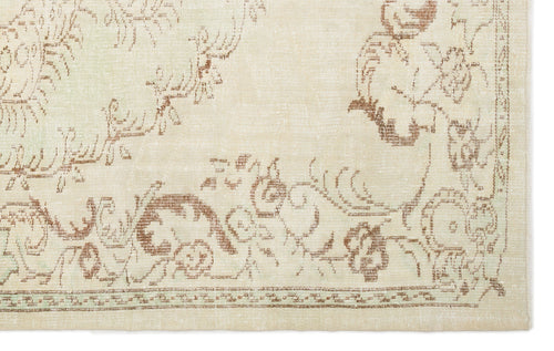 Load image 1 in gallery view. Cream rug with a distressed brown floral medallion pattern and a decorative border.