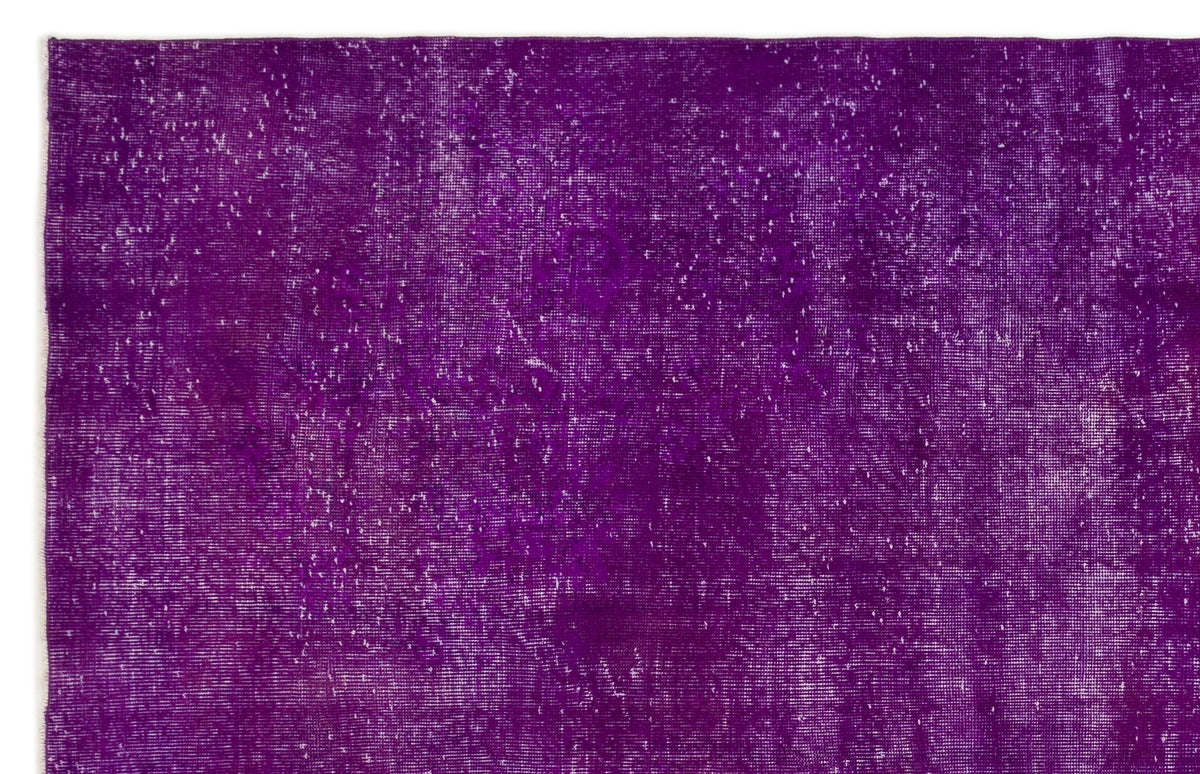 Deep purple vintage-style rug with a distressed, faded texture and white worn-in details.