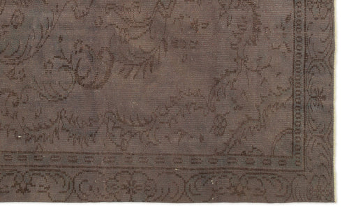 Load image 1 in gallery view. Dark brown flatweave rug with a subtle, tonal floral medallion pattern and a decorative border.