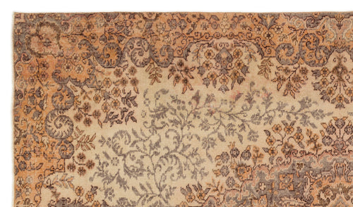 Load image 1 in gallery view. Beige, orange, and charcoal vintage-style rug with a dense, distressed floral and vine pattern.