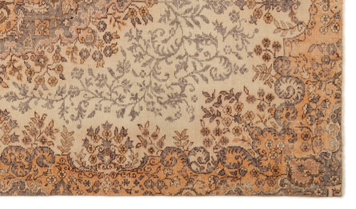 Load image 1 in gallery view. Beige, orange, and charcoal grey rug with a distressed floral and vine pattern.