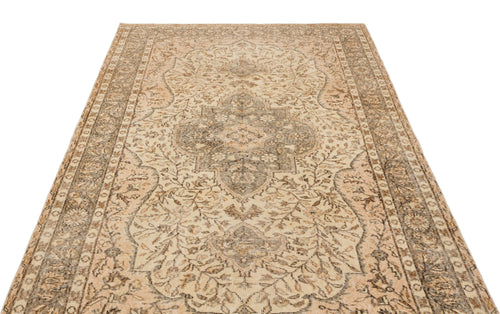 Load image 1 in gallery view. Beige and brown vintage-style rug with a distressed floral medallion pattern and ornate border.