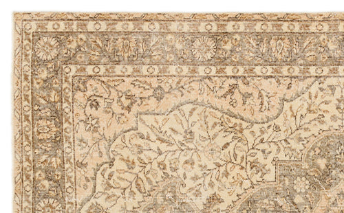 Load image 1 in gallery view. Beige and brown traditional rug with a distressed floral medallion pattern and geometric border.