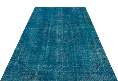 Load image 1 in gallery view. Teal distressed area rug with a faded central medallion and traditional border pattern on a white background.