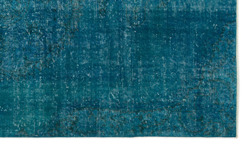 Load image 1 in gallery view. Teal rug with a distressed, faded texture and subtle dark outlines of a traditional medallion pattern.