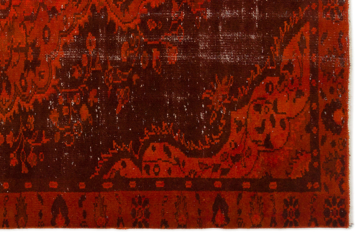 Deep red and dark brown distressed rug with a traditional ornate floral medallion pattern.