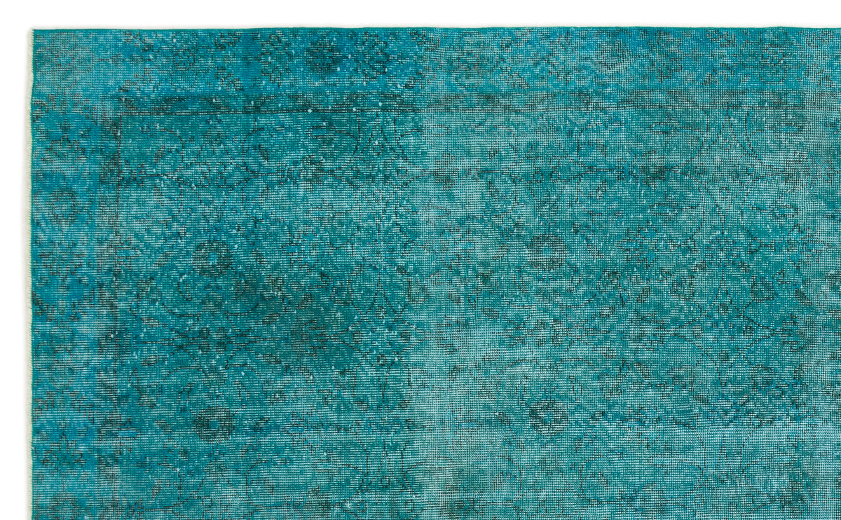 Teal distressed rug with a faded traditional medallion pattern.